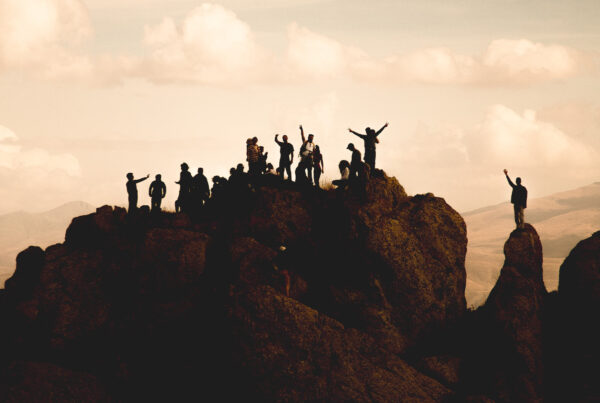 group of happy people on top of a mountain